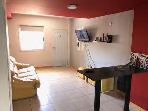 a living room with a table and a couch at Excelente Duplex en Consorcio Privado c/ cochera in San Juan