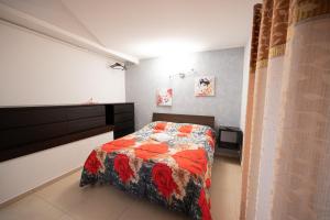 ein Schlafzimmer mit einem Bett mit einer Decke darauf in der Unterkunft Affittacamere Artemisia in Battipaglia