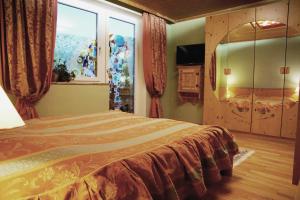 a bedroom with a bed and a large window at Apartment "Gustav Klimt" in Zell am See