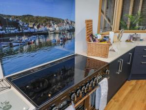 a kitchen with a stove with a picture of a harbor at Guisborough Town Hall in Guisborough