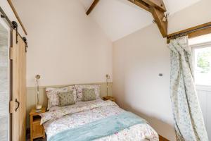 a bedroom with a bed and a window at Foxglove in Whitby