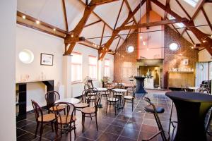 a large room with tables and chairs in a building at Vakantiewoning L'Eau Tendre in Ellezelles, met wellness, buitenzwembad en paardenstalling in Ellezelles