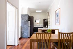 eine Küche und ein Esszimmer mit einem Tisch und Stühlen in der Unterkunft Steps from Manly Beach in Sydney