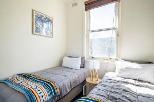 1 dormitorio con 2 camas y ventana en Manly Sunset Lagoon, en Sídney