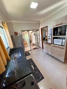 a kitchen with a sink and a counter top at Casa Dos Papagaios in Bonito