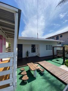 un patio con una mesa de madera y algunas setas en Casa conchas das Caravelas, en Governador Celso Ramos