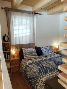 a bedroom with a bed and a window at Tabiá sui Prá - appartamento monolocale Anna in Falcade