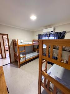 a room with two bunk beds and a hallway at Casa Dos Papagaios in Bonito