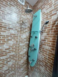 a shower in a brick wall with a blue object at Sweet Dreams Suites Cosy Studio Piata Romana in Bucharest