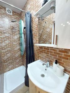 a bathroom with a sink and a shower and a tub at Sweet Dreams Suites Cosy Studio Piata Romana in Bucharest