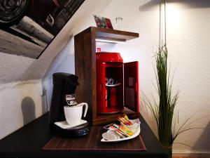 a coffee maker on a table with a plate of food at Apartment-96 in Weingarten