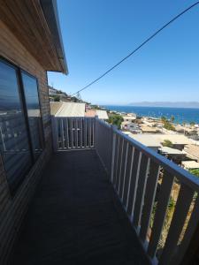 a balcony with a view of the ocean at Casa amplia y acogedora in Guanaqueros