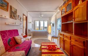 a living room with a couch and a room with a bed at Nice Apartment In Torrevieja With Wifi in Torrevieja