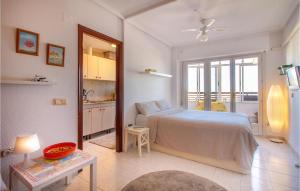 a bedroom with a large bed and a kitchen at Nice Apartment In Torrevieja With Wifi in Torrevieja