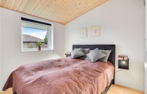 ein Schlafzimmer mit einem großen Bett und einem Fenster in der Unterkunft Nice Home In Strby With Kitchen in Strøby
