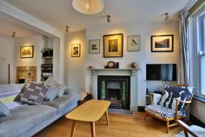 a living room with a couch and a fireplace at BRAUNTON SAMPHIRE 2 Bedrooms in Braunton