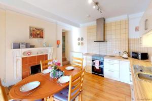 a kitchen with a wooden table and a dining room at BISHOPS TAWTON OVERTON HOUSE 2 Bedrooms in Bishops Tawton