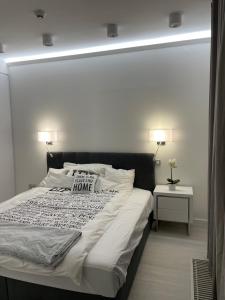 a bedroom with a large bed with a welcome home pillow on it at Lovely new apartment by the Parliament in Budapest