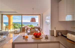 a kitchen with a table with a bowl of fruit on it at 3 Bedroom Cozy Apartment In Villajoyosa in Villajoyosa