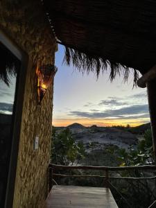 a room with a view of the desert at sunset at Bangalô Encantador Praia da Baleia in Itapipoca