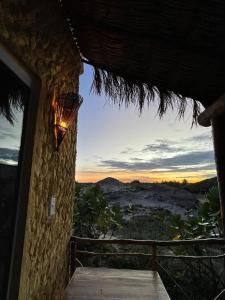 a room with a view of the desert at sunset at Bangalô Encantador Praia da Baleia in Itapipoca +19 photos