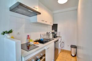 a kitchen with a sink and a counter top at Studio spacieux avec terrasse et parking in Viry-Châtillon