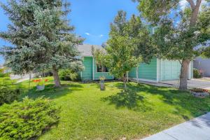 a green house with trees in a yard at A Colorado Room With a View - King in Colorado Springs