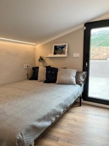 łóżko w pokoju z dużym oknem w obiekcie La Ruta w mieście Confrides