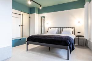 a bedroom with a bed with a blue and white wall at Odra Apartments in Wrocław