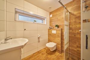 a bathroom with a toilet and a sink at Residence Ruth in Janske Lazne