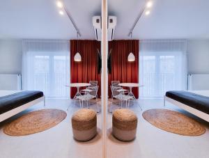 pokój z 2 łóżkami i 2 stołami i krzesłami w obiekcie Odra Apartments we Wrocławiu