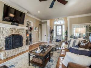 a living room with a couch and a fireplace at Executive home w/Study + pool near Lake in Rockwall