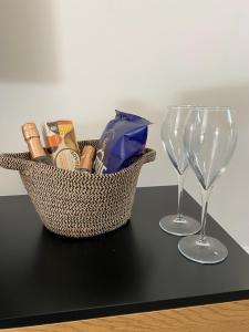 a basket and two wine glasses on a table at February Bliss Special, Unwind in Style with Our Exclusive SA PROMO, BOOK NOW in Woolwich