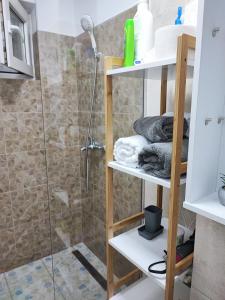a bathroom with a shower and some towels at Apartament în Buzău in Buzau