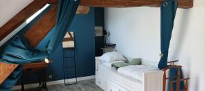 1 dormitorio con paredes azules y 1 cama blanca en L'auberge 10 à 15 pers 30min zoo beauval chambord cheverny en Langon