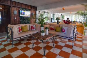 a living room with two couches and a table at Hotel Rancho Constanza & Cabañas de la Montaña in Constanza