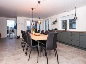 uma cozinha e sala de jantar com uma mesa de madeira e cadeiras em Holiday home Haderslev XLVII em Haderslev
