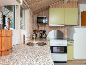 a kitchen with a sink and a stove at 6 person holiday home in Hemmet-By Traum in Hemmet +28 photos