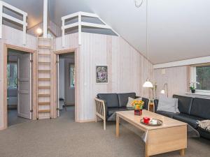 a living room with a couch and a loft bed at Three-Bedroom Holiday home in Hemmet 35 in Hemmet