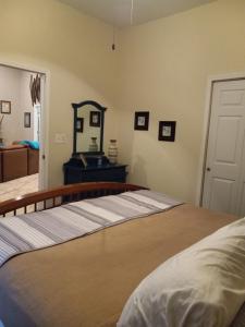 a bedroom with a bed with a mirror on the wall at The Barrel House Bed & Breakfast in Loretto