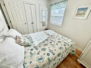 a bedroom with a bed with a quilt on it at Boston Commons 101 Condo in Myrtle Beach