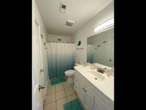 a bathroom with a sink and a toilet and a mirror at Boston Commons 101 Condo in Myrtle Beach