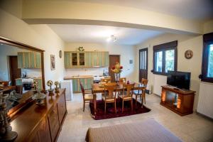 a kitchen and dining room with a table and chairs at Mountain house Lailias 