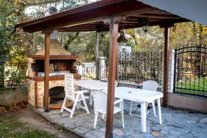 a gazebo with a table and a fireplace at Mountain house Lailias 