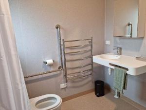 a bathroom with a toilet and a sink at Mangorei Heights - New Plymouth in New Plymouth