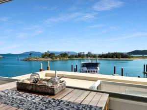 a balcony with a view of the water and a boat at Blue on Blue Studio Room 1272 in Nelly Bay