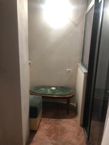 a small room with a table and a stool at Ani Apartament in Durrës