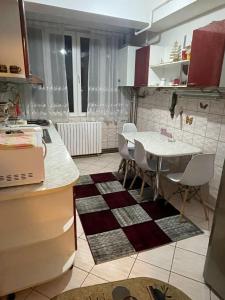 a kitchen with a table and a table and chairs at Sophia Lupeni Straja in Lupeni