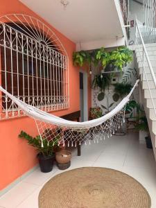 a room with a white spiral staircase with plants at Aconchego de Itapuã in Salvador