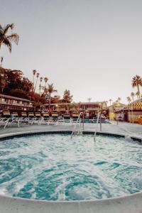 a large swimming pool with chairs in a resort at The Atwood Hotel San Diego - SeaWorld/Zoo in San Diego